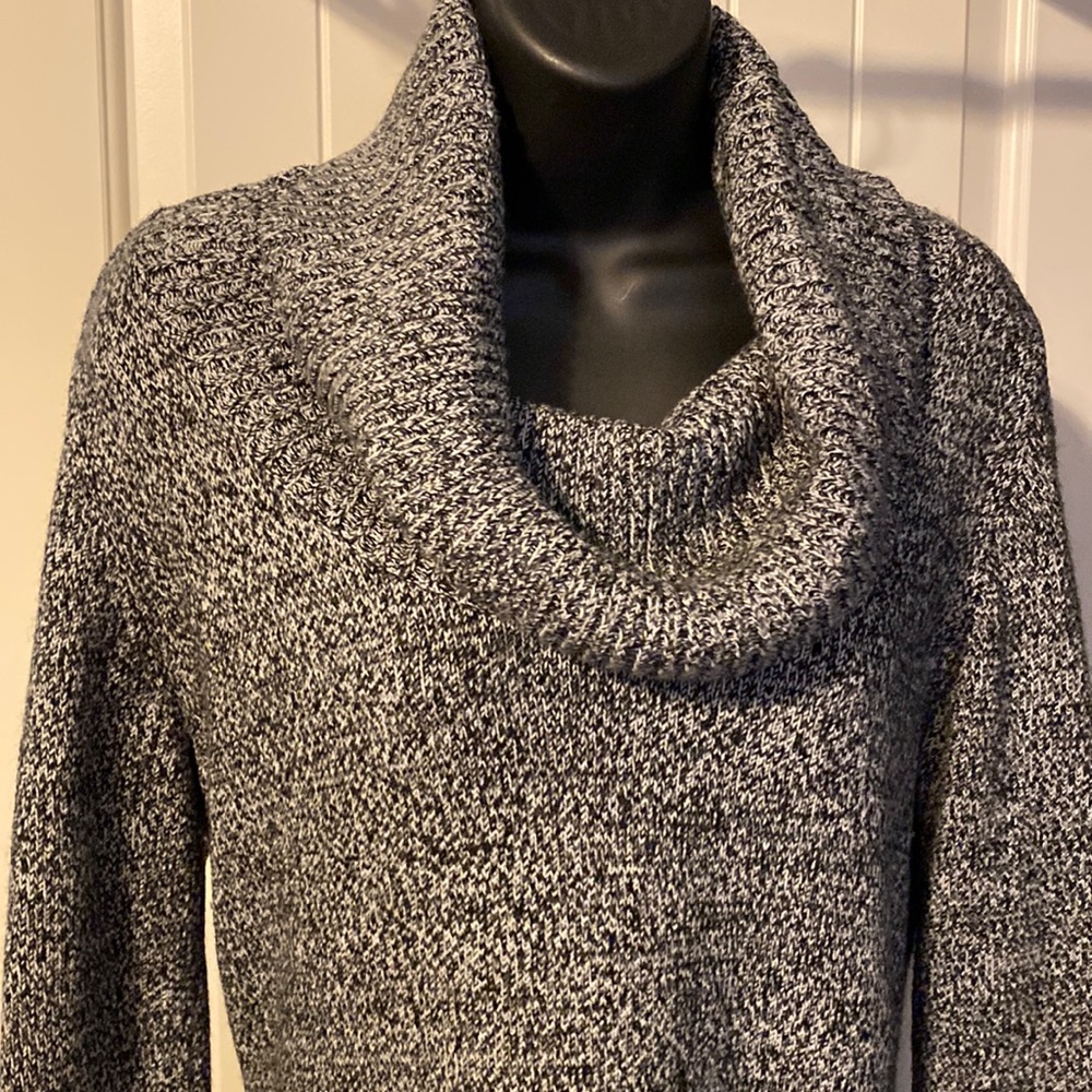 Black and white cowl neck sweater dress with two patch pockets.